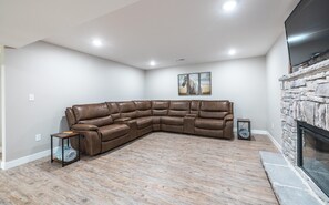 Large sectional couch with 4 reclining chairs and usb charging ports in each arm rest.