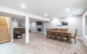 8 person rustic wood dining table.  Between the dining table, island seating, and bar seating there are 16 seats.