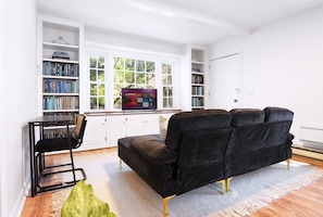 Cozy living room with smart Roku TV and dedicated workstation.