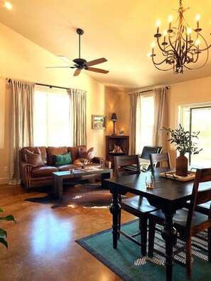 Downstairs open concept living area with leather sofa and comfortable furnishing