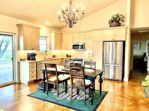 Spacious kitchen outfitted with quality cookware and serving dishes.