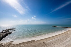 The balcony offers breathtaking views overlooking the private beach, providing a serene and picturesque backdrop for a truly enchanting experience.