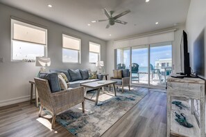 The living room is bathed in an abundance of natural light, creating a bright and inviting atmosphere.