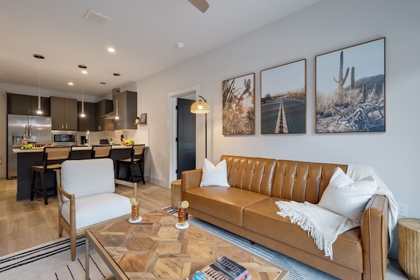 2nd Unit: Bright living room with comfortable seating, smart TV, designer decor, and access to the outdoor patio.