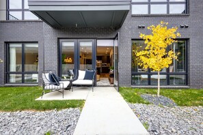 1st Unit: Outdoor patio space accessible from the living area complete with outdoor furniture.