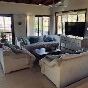 lounge opens onto deck to capture breezes Seating for 9 with big screen tv
