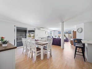 Gather around the large dining table, perfect for family feasts and special moments.
