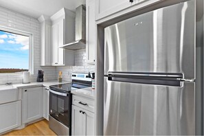Unit 301 Kitchen:
Cook in comfort while enjoying peaceful views from the beautifully designed chef’s kitchen. The spacious quartz island is perfect for sipping your morning coffee or serving up a delicious meal. Outfitted with stainless steel appliances, custom cabinetry, a tile backsplash, built-in trash bins, and a spice rack, this modern kitchen has everything you need for a...