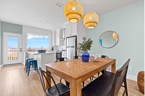 Unit 301 Dining Area:
Gather around the stylish dining space, thoughtfully furnished with upscale décor and a stunning designer chandelier. The table comfortably seats six, offering the ideal ambiance for enjoying meals and creating lasting memories with your loved ones.