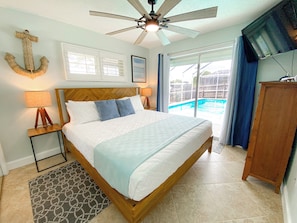 Bedroom 2 with King size bed, TV, closet and pool access. 