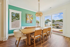 This bright and sunny room allows everyone to enjoy a meal together.