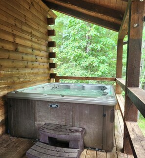 Covered hot tub in a secluded setting that is perfect even in the rain or snow!