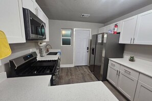 The full kitchen, with all of the utensils you could need to cook a hearty meal.