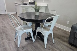 The breakfast/dining area, along with the living room and the 65'' TV for your entertainment