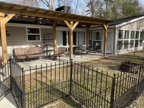 Outdoor porch with covered area with lights and fans and comfortable seating