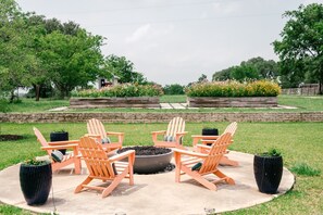 Enjoy the gas fire pit in the back yard with a view of the pool, raised garden beds and gazebo!