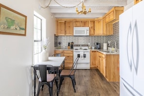Full kitchen with Kuerig Coffee Maker and Full-Size Refrigerator!