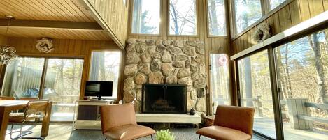 Welcome to your main living area, filled with soaring windows and a fireplace