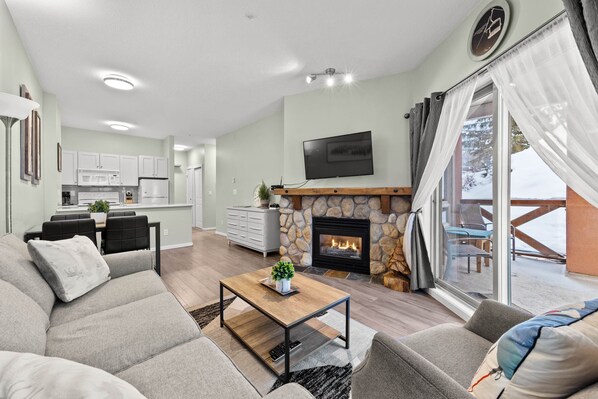 Remodeled open and modern living space complete with new furniture and a gas fire place.