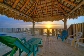 Relax on the loungers under the shaded poolside cabana.