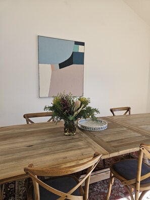 Oak table comfortably sits 10 guests with cutlery, crockery and glasses.