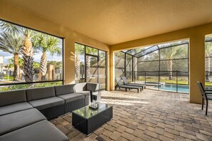 Relax in style on this spacious screened patio with a private pool view, perfect for soaking up the sun and enjoying the serene surroundings.