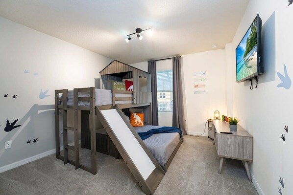Fun-filled kids' room with a bunk bed and slide, perfect for a playful stay!