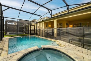 Relax in your private pool and hot tub oasis, complete with a screened enclosure for ultimate comfort and privacy.