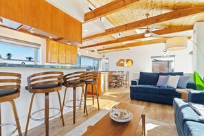 Modern meets cozy in this sunlit open-plan living space, perfect for both relaxing and entertaining.