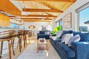 Welcome to our bright and airy living space, flooded with sunlight and ocean breezes pouring in from the large windows.