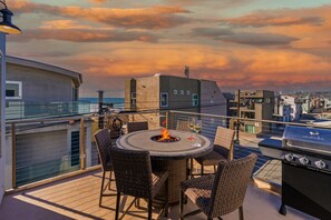 Cozy up by the crackling fire pit on the balcony and savor breathtaking views of the ocean just steps away.