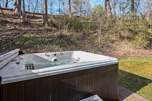 Dive into bliss! This hot tub is the perfect spot to unwind and soak in the beauty of the woods.