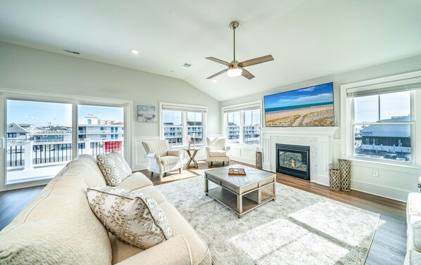 Bright and spacious living room with gas fireplace and flat screen TV
