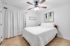 Secondary bedroom with queen bed, blackout curtains and smart TV