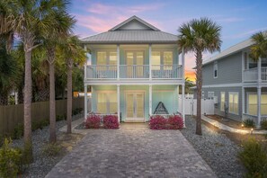 Charming two-story vacation retreat featuring a cozy downstairs porch and a tranquil upstairs balcony, offering the perfect blend of relaxation and scenic views