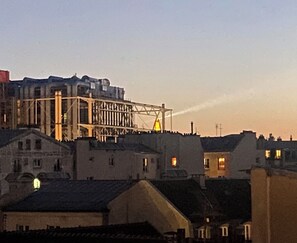 Evenings one can perceive light beams from the top of the Eiffel tower 