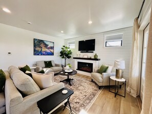 Living room with fireplace and Erin Hanson art featuring gorgeous gem colors.