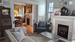 Front sitting room with gas fireplace; pocket doors open to dining room