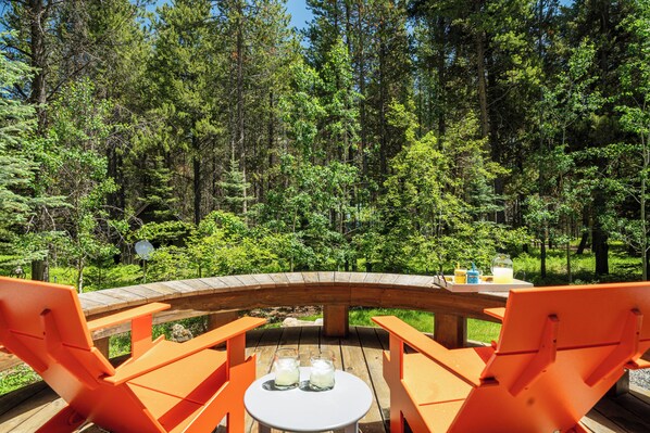Kick back in bright Adirondack chairs and take in the peaceful forest surroundings, the perfect spot for morning coffee or an evening drink.