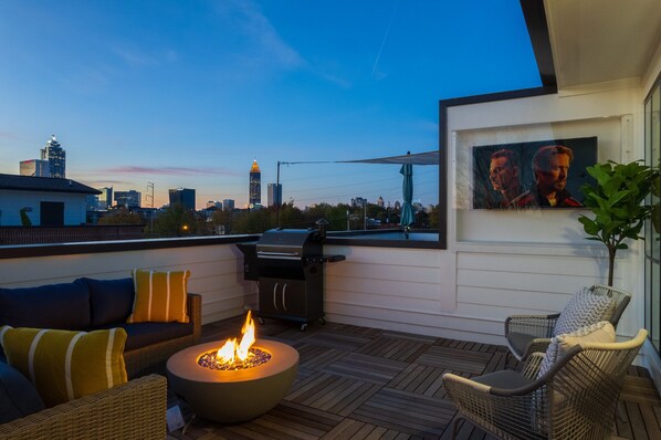 Rooftop with Skyline views

Amenities include 50k BTU Firepit, a TV, a BBQ grill, and enough seating for 10