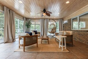 Large sunroom with lounge area and games.