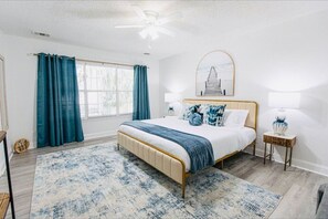 eautifully designed bedroom with a plush bed, stylish decor, and large windows bringing in plenty of natural light for a restful stay.