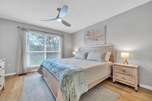 Our master retreat has a beautiful king-sized bed, outfitted with the amazing linens and pillows ensuring a night of restful sleep. The bedroom features a TV, dresser and a large-picturesque window with garden views.