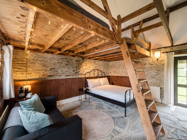 Master bedroom and seating area Ventry Farm Rainbow Cottage 