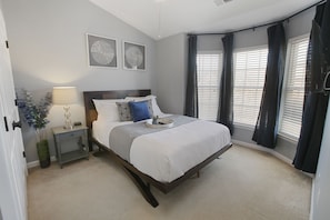 Bedroom 2 has a queen sized bed, soaring vaulted ceiling, 43" Smart TV, closet.