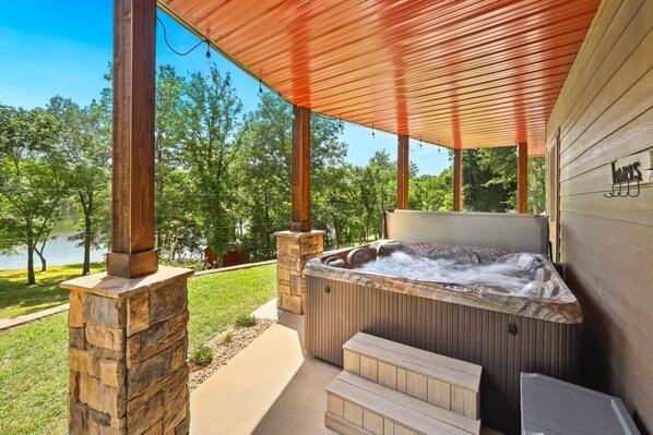 Unwind in our private outdoor hot tub under the canopy of stars, surrounded by serene views of the water.