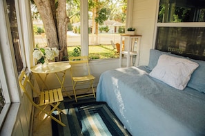 Screened-in porch with daybed. Please note that traffic is visible and audible from the porch.