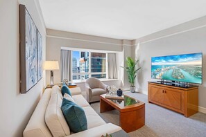 Seaside Chic: Unwind in this studio's living area, where coastal charm meets modern design. Floor-to-ceiling windows frame an awe-inspiring ocean view, creating a stylish haven in the heart of Miami