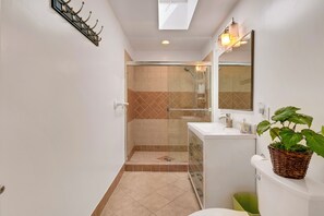 Private, en-suite bathroom with shower, sink and vanity, toilet, fresh towels