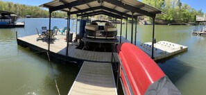 Boat dock with 2 jet ski slips, 2 kayaks and a canoe. Our boat stays under cover